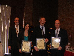 In March, Strimpler (far l) presents the chapter's newest corporate members with commemorative plaques. Representing their organizations are (l-r) Ardena Artale, Mission 1st Group; Norman Goldsmith, Sarnoff Corporation; and Chris Healy, Planet Associations Incorporated.